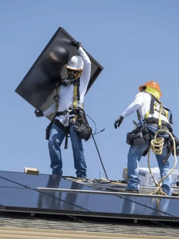2 roofers performing solar installation